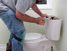 Laurence is repairing a broken toilet